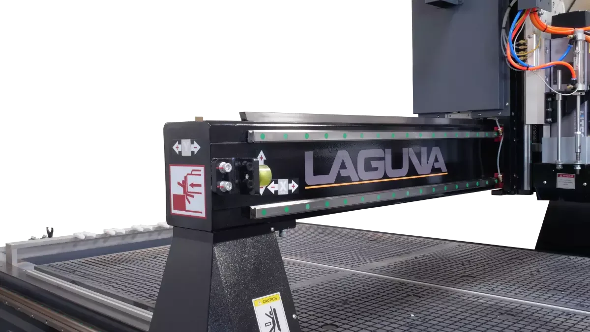 SmartShop® M gantry with the Laguna name on the beam, over the vacuum table, machine idle